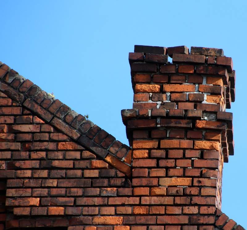 Signs Your Fox Lake Home Needs a Chimney Inspection Blog Article - Damaged chimney on an Fox Lake home showing cracks and missing mortar